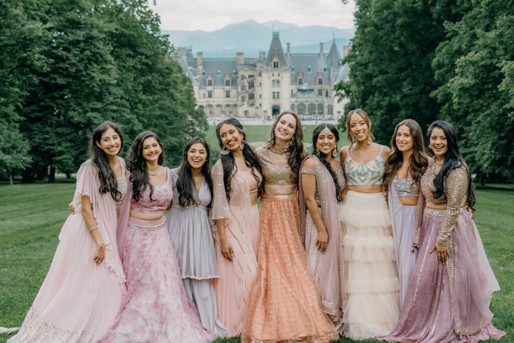 Bridesmaids in pastel lehengas in front of Biltmore House
