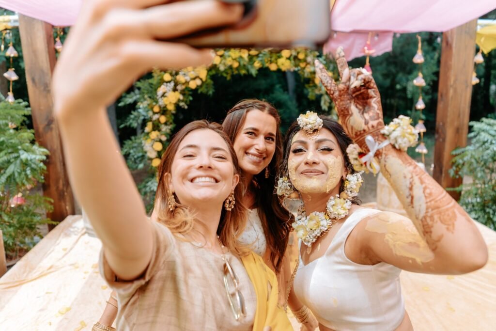 Bride and friends laughing during the Pithi ceremony